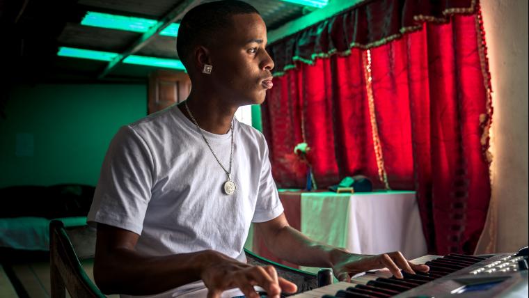 A young man playing the piano